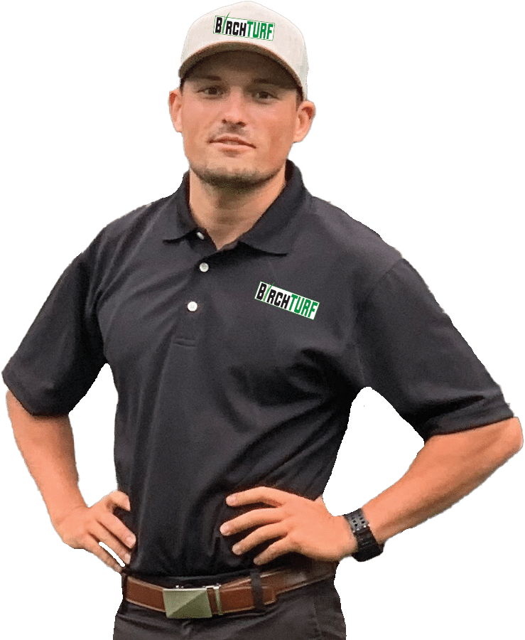 Garret Birchenough, Owner of BirchTurf, waste up with hands on hip; black shirt and tan baseball hat - both with BirchTurf logos